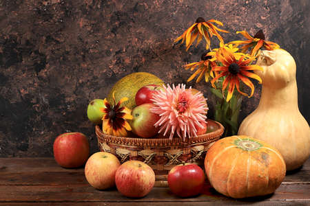 Happy Thanksgiving concept, autumn background with seasonal pumpkins, melons, apples and flowers on an old wooden background, copy space, selective focus.の写真素材