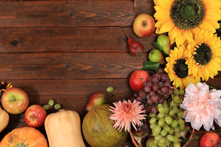 Happy Thanksgiving concept, autumn background with seasonal fall nature berries, pumpkins, melons, apples, grapes and flowers on wooden background, top view, copy space, flat lay. , selective focus.の写真素材