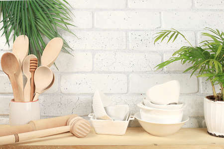 Kitchen utensils and utensils, palm flower on wooden table, home interior, zero waste concept,...