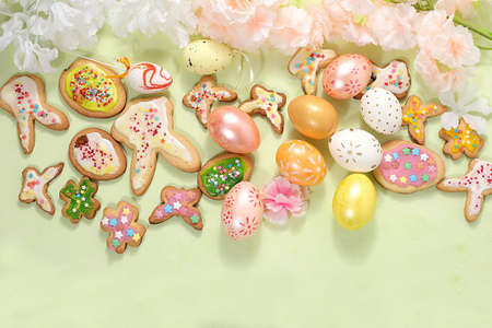 Festive easter banner, spring composition with decorated eggs, cookies and blooming flowers,...