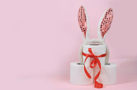 Toilet paper rolls as a Christmas or birthday present, used as a hygiene product in washrooms, a very scarce commodity in the energy crisis in Europe, selective focusの写真素材