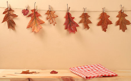 Empty wooden table for product display and maple leaves, minimal autumn concept, Creative autumn...