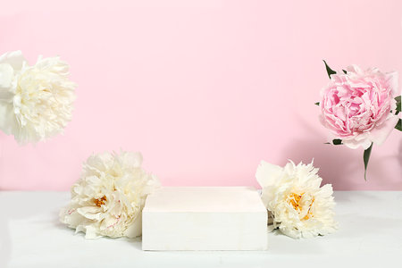 Abstract background with natural wooden podium and peonies flowers, minimal floral composition, empty showcase for beauty products showcase or presentation, selective focusの写真素材
