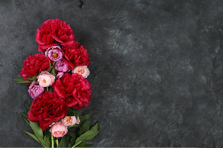 Floral arrangement with place for text, beautiful peony flowers on old dark background grunge ,summer banner,floral greeting card for wedding,birthday,template for design,の写真素材