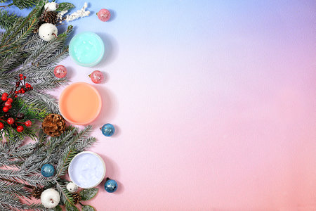 Winter skin care concept, banner, Christmas and New Year spa composition with fir branches, decorations and cosmetics with space for text, spa salon promotional invitation, selective focusの写真素材