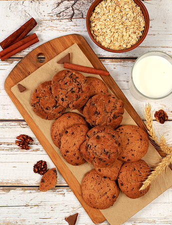 Homemade chocolate chip and nut gluten free oatmeal cookies with ears on wooden background,modern...