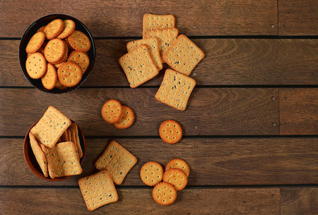 Dry French cracker with sesame seeds on wooden background.Homemade chocolate chip cookies with gluten free nuts,modern bakery concept. Healthy breakfast with ingredients, top view, selective focus,の写真素材