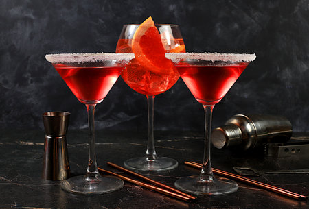 Assortment of alcoholic cocktail Aperol spritz and red martini in glasses on a dark background, bar concept, alcoholic drinks at a party, restaurant advertising, selective focusの写真素材