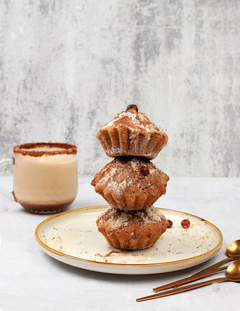 Chocolate muffins with nutmeg and cinnamon eggnog on a concrete background, cozy breakfast concept,...