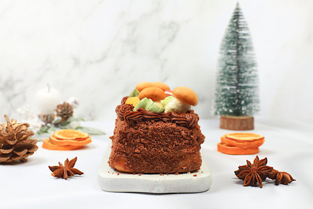 Homemade winter dessert, stollen or strudel with sweet cream filling, nuts, cinnamon and poppy...