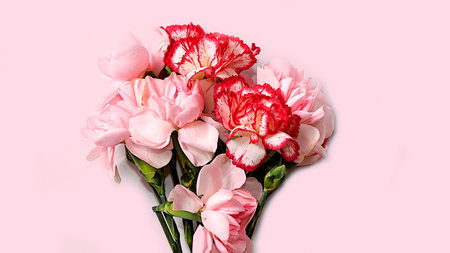 Floral arrangement with carnations on a pink background. Concept for Valentine's Day or Women's Day,...