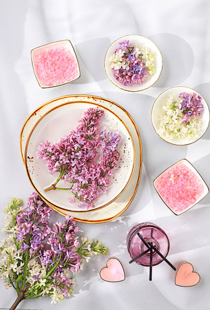 Fragrant pink salt, lilac water and lilac flowers. Spa and wellness composition, aromatherapy and skin care, lifestyle and organic cosmetics concept, salon invitation and advertisement, selective focusの写真素材