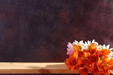 Empty wooden table with lilies,daisies,mallow flowers, summer and autumn banner for product...