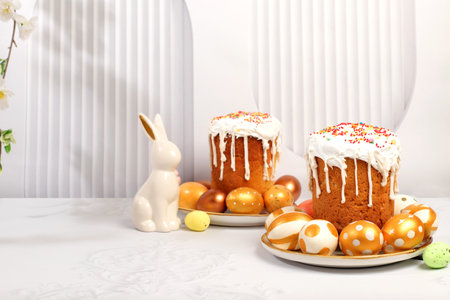 Abstract Easter composition with traditional Russian kulich with meringue and decorated eggs on elegant kitchen table with spring sakura flowers. Happy Easter concept. Screen bannerの写真素材
