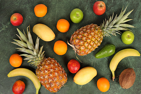 Summer tropical fruits on concrete table, source of vitamin C, healthy vegan products for healthy lifestyleの写真素材