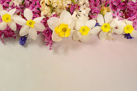 Abstract floral arrangement for screen and design template. Beautiful flyer with white hyacinths, daffodils and blue muscari on elegant bright background. Spring card, elegant natural beauty concept, gift for loved ones.の写真素材