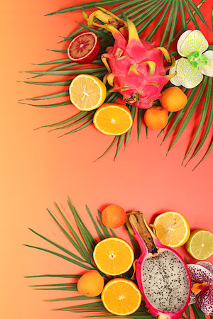 Dragon fruit, pitaya, oranges, lemons, apricots, orchid flowers, grapefruit on palm leaves, tropical...
