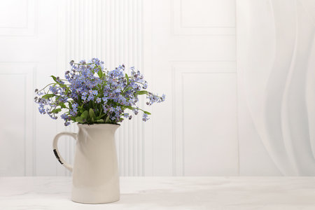 Abstract flower arrangement,Beautiful spring forget-me-not flowers in vase on light background,flyer. still life and template for design,floral holiday card and summer greeting concept,selective focusの写真素材