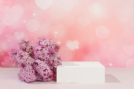 Empty podium with spring lilac flowers.Abstract floral arrangement with lilac flowers, banner. Creative template for your design.Minimal modern aesthetics, elegant beauty concept,の写真素材