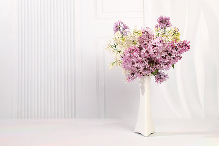 Abstract floral arrangement and banner for screen.Still life with beautiful spring flowers blooming white lilac in vase on elegant background,floral holiday card with summer greeting concept.の写真素材