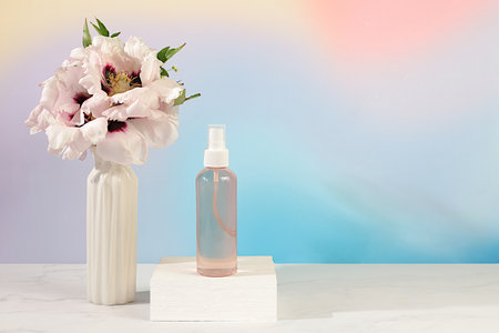 Spa salon advertising card, Wellness composition with rose water, fresh flowers of mountain peony and columbine, concept of natural self-care and healthy lifestyle, abstract composition with flowersの写真素材