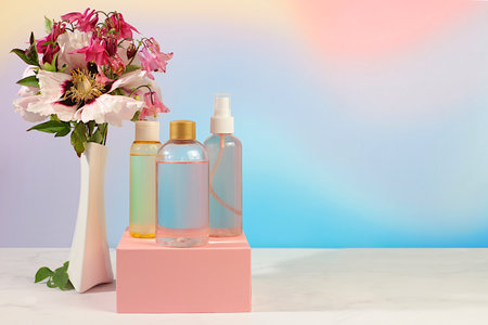 Spa salon advertising card, Wellness composition with rose water, fresh flowers of mountain peony and columbine, concept of natural self-care and healthy lifestyle, abstract composition with flowersの写真素材