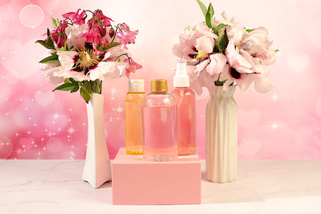 Spa salon advertising card, Wellness composition with rose water, fresh flowers of mountain peony and columbine, concept of natural self-care and healthy lifestyle, abstract composition with flowersの写真素材