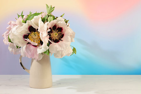 Abstract flower arrangement.Still life with spring flowers mountain peony and columbine in vase on elegant modern table,template for your design with space for text,minimal beauty concept,beautiful flower card,の写真素材