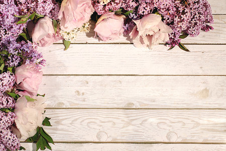 Abstract floral composition and banner for screen, Beautiful spring blooming branches of lilac and mountain peony on sunny background. Still life with place for text, Floral holiday card with summer greeting concept.の写真素材