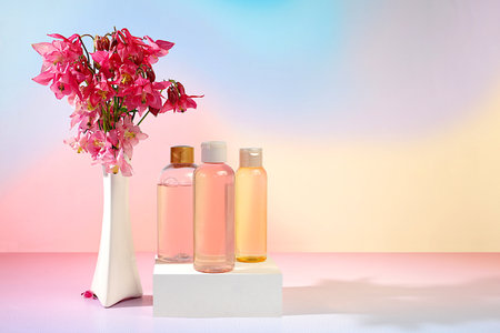 Wellness composition with rose water and fresh columbine and aquilegia flowers, spa salon advertising card, natural self-care and healthy lifestyle concept, abstract composition with flowersの写真素材