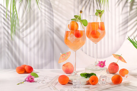 Royal lemonade cocktail with peach, apricot, mojito with tequila, gin, rum, vodka, liqueur, lime, ice and fresh mint, bar and party concept, restaurant and cafe advertising card, summer alcoholic and non-alcoholic drinksの写真素材