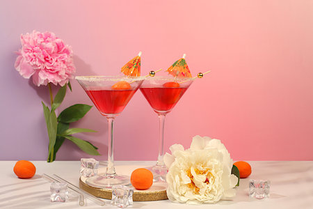 Minimal summer party concept, advertising banner for bar, cafe. Modern still life with pink martini, summer alcoholic cocktail with apricot for party and peonies on elegant modern background,の写真素材