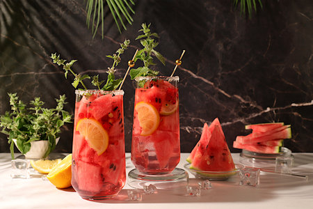Refreshing summer homemade cocktail, sangria, lemonade with watermelon, apricot, mint and lemon,...