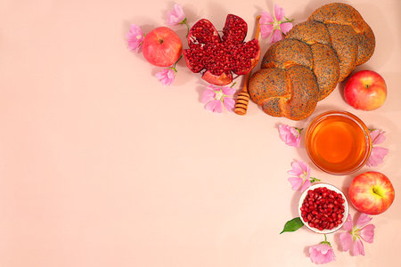 Jewish holiday Rosh Hashanah concept with apples, honey, pomegranate, challah bread and flowers for greeting card, creative layout and template for Jewish New Year and Thanksgiving, autumn banner for designの写真素材
