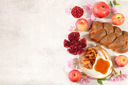 Jewish holiday Rosh Hashanah concept with apples, honey, pomegranate, challah bread and flowers for greeting card, creative layout and template for Jewish New Year and Thanksgiving, autumn banner for designの写真素材