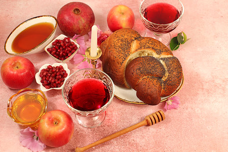 Advertising banner with symbols of Jewish New Year, template with honey, apples, pomegranate, red wine, challah bread and flowers. Creative composition for congratulations on Jewish holiday Ro hashanah,の写真素材