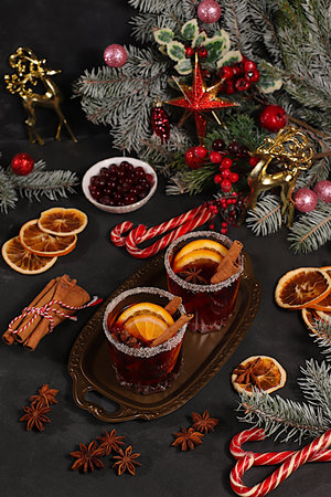 Strong alcoholic or non-alcoholic cocktail, mulled wine with spices, star anise, cranberry, orange, apple and cinnamon, a warming winter drink in the cold season, a Christmas festive grog, a winter compositionの写真素材