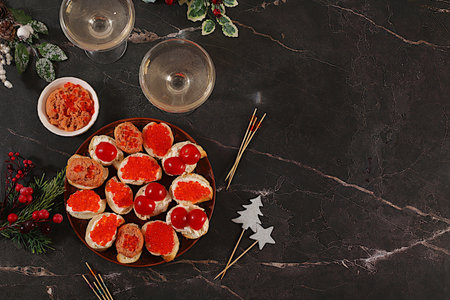 Christmas and New Year's dishes, a selection of appetizers and refreshments for festive tables and buffets. Dishes with pate baguette and caviar, smoked salmon, soft cheese and tomatoes, menus for cafes and restaurants.の写真素材