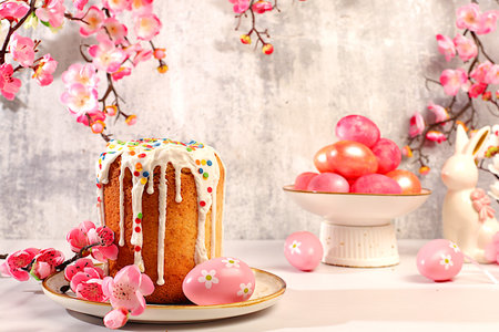 Abstract Easter composition featuring a traditional Russian meringue kulich and decorated eggs on an...