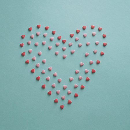 Blue background with small red and pink hearts making big one.の写真素材