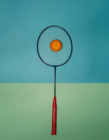 Arrangement with red racket and orange. Minimal style.の写真素材