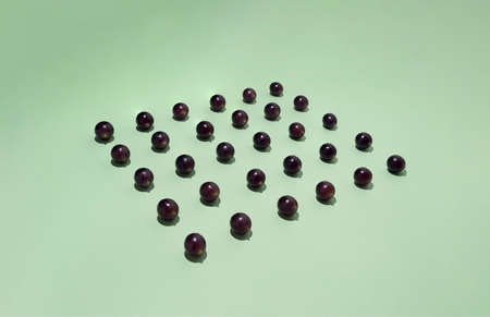 Grapes arranged in a square. Minimalist autumn composition. Side view.