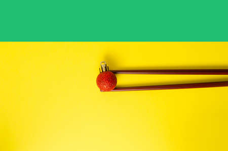 Chinese New Year. The chopsticks hold a red Christmas ball.の写真素材