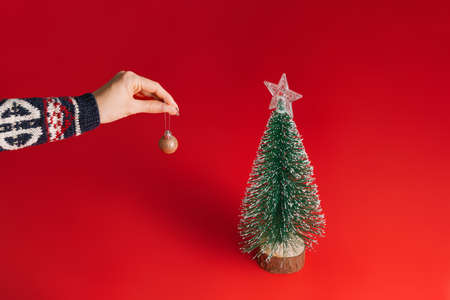 Christmas tree decoration. female handの写真素材