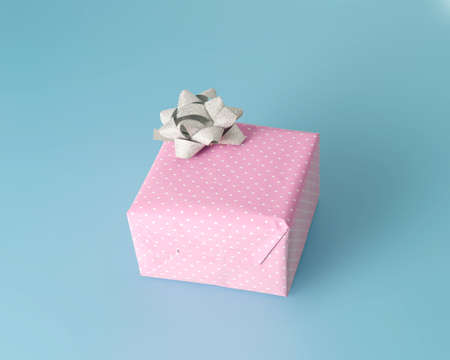 Pink gift with a bow on a blue background