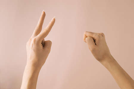 Hands Gesture for Rock  Scissor Game, isolated on pink background.の写真素材