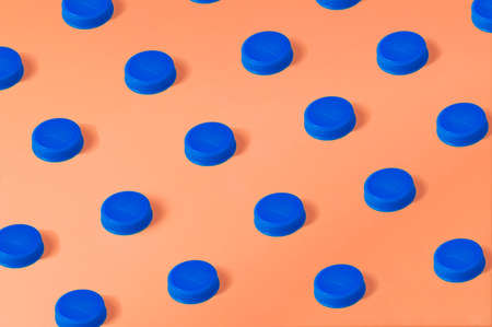 Blue plastic bottle cap on orange backgroundの写真素材