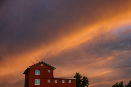 House and beautiful sunset on backgroundの写真素材