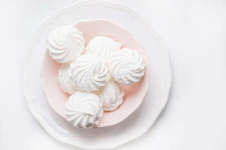 Marshmallows in pink plate  on a white background.
