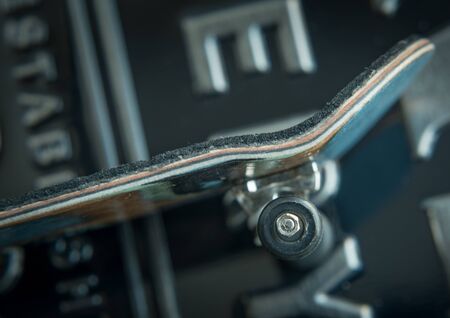 Front view of the back of a skate board with black wheels
